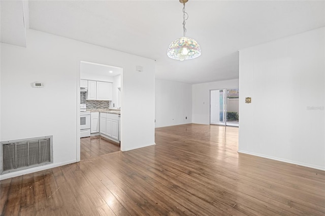 unfurnished living room featuring hardwood / wood-style floors