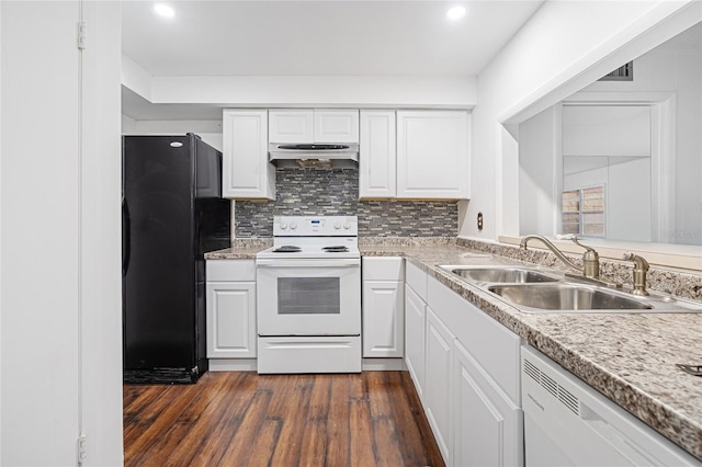 kitchen with electric range, dishwasher, sink, black refrigerator, and white cabinets