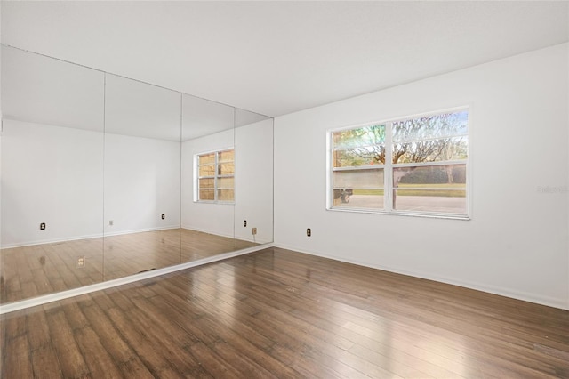 spare room with hardwood / wood-style flooring