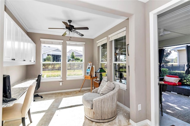 carpeted office featuring crown molding and ceiling fan