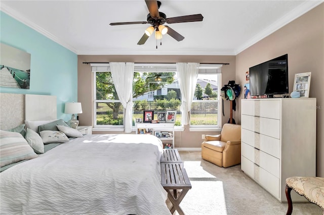 carpeted bedroom with multiple windows, ornamental molding, and ceiling fan