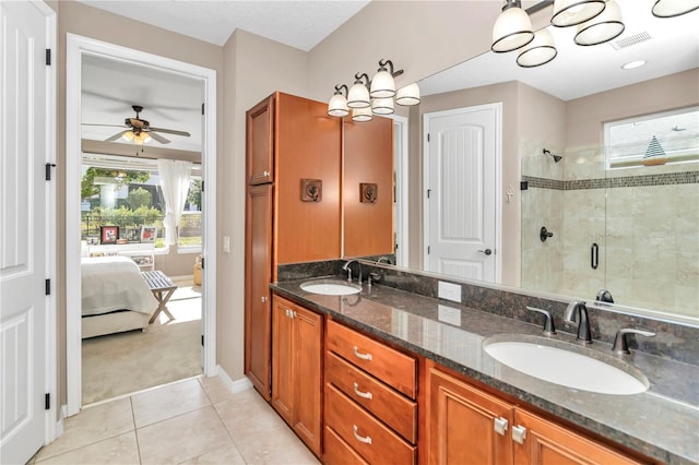 bathroom featuring vanity, tile patterned flooring, and a shower with shower door