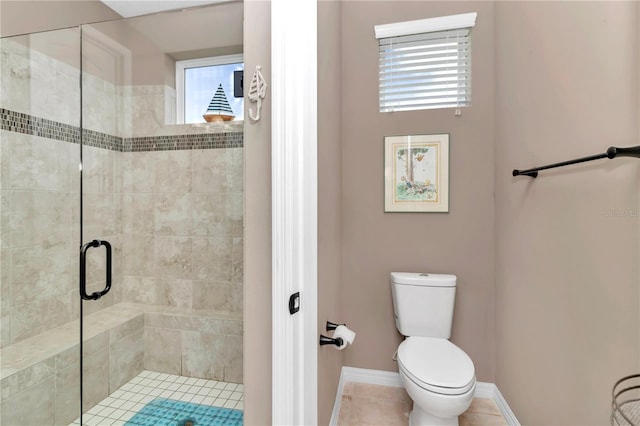 bathroom featuring tile patterned flooring, walk in shower, and toilet