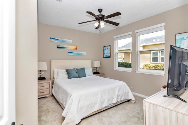 bedroom featuring ceiling fan and light colored carpet