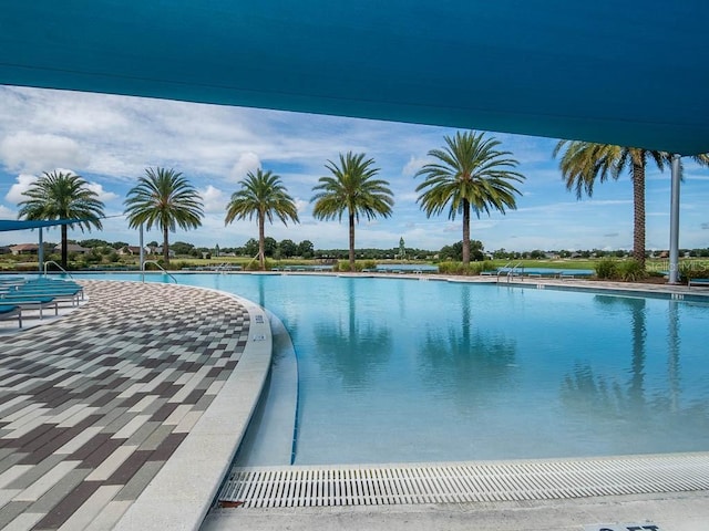 view of swimming pool featuring a water view