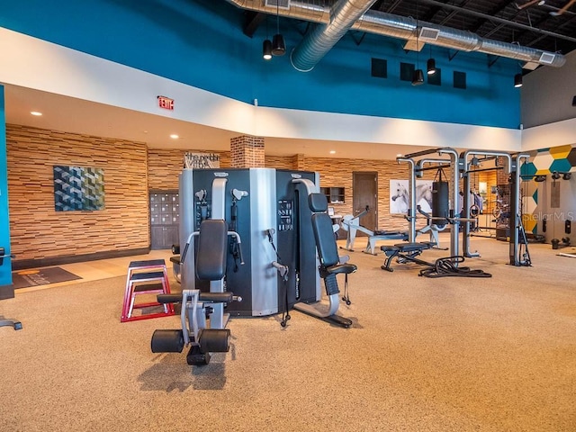 exercise room with a towering ceiling