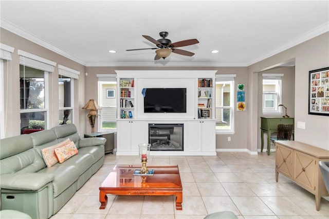 living room featuring ornamental molding, a healthy amount of sunlight, and light tile patterned flooring