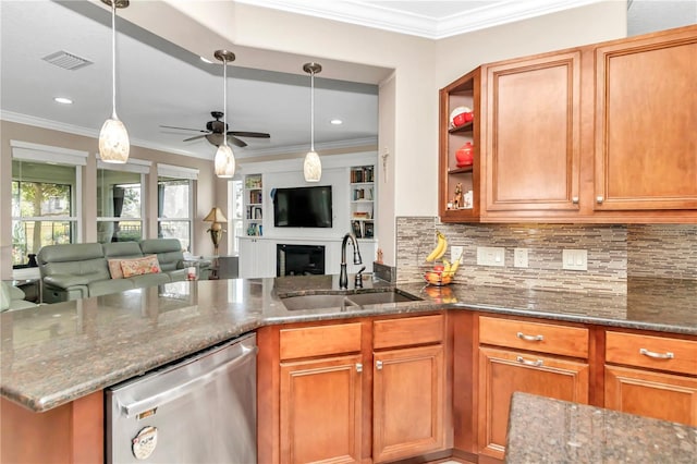 kitchen with pendant lighting, sink, stainless steel dishwasher, and dark stone counters