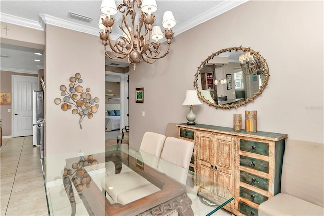 dining room featuring crown molding, a notable chandelier, and light tile patterned floors