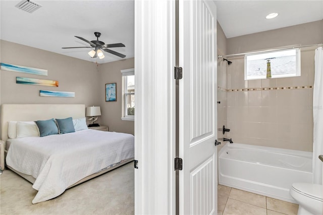 tiled bedroom with ceiling fan and multiple windows