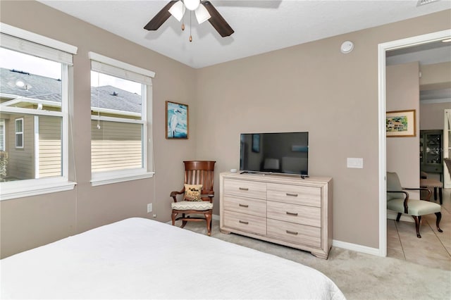 bedroom with light carpet and ceiling fan