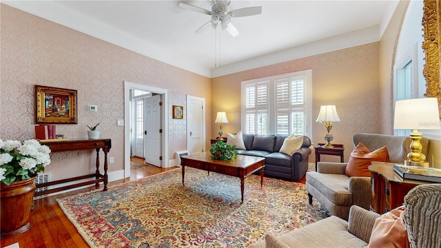 living room featuring ceiling fan and hardwood / wood-style flooring