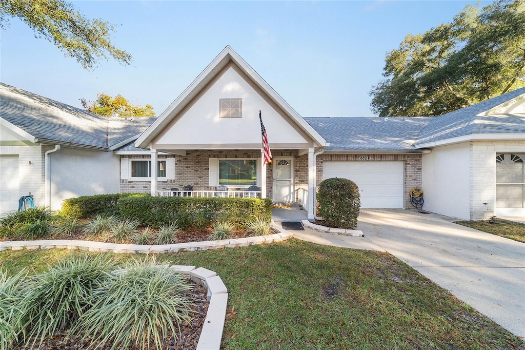 view of front of house featuring a porch and a garage