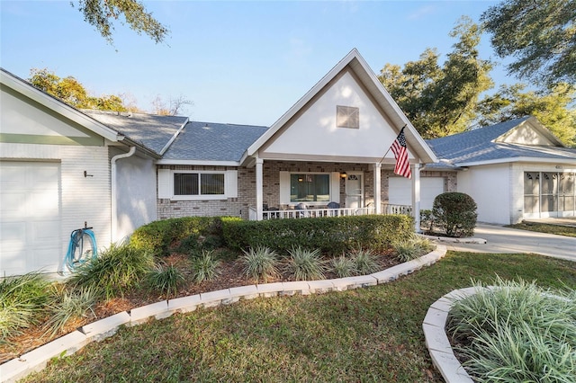 view of front of house featuring a garage and covered porch