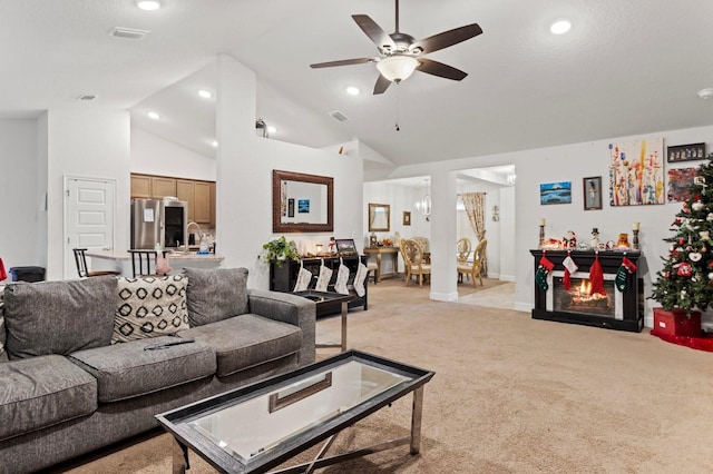 living room with ceiling fan, light carpet, and high vaulted ceiling