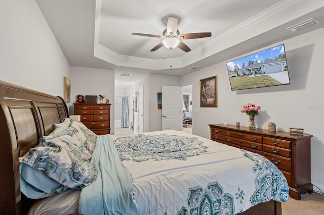 carpeted bedroom with a raised ceiling, ceiling fan, and crown molding