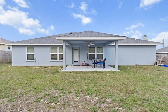 rear view of property featuring a patio, ceiling fan, and a lawn