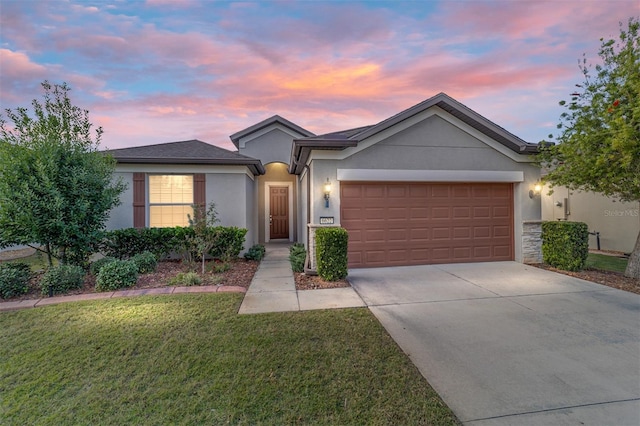 single story home with a yard and a garage