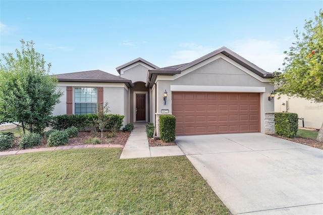 ranch-style home with a garage and a front lawn