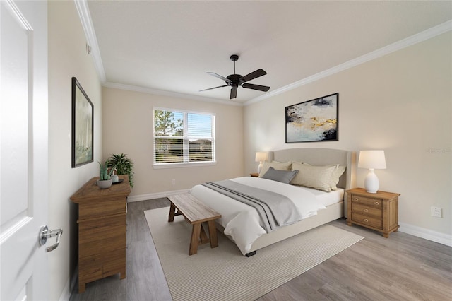 bedroom with ceiling fan, crown molding, and wood-type flooring