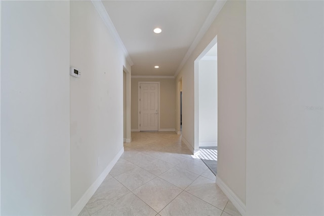 hall featuring light tile patterned floors and crown molding