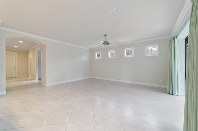 tiled spare room featuring ceiling fan and crown molding