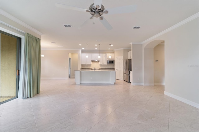 unfurnished living room with ceiling fan, crown molding, and sink