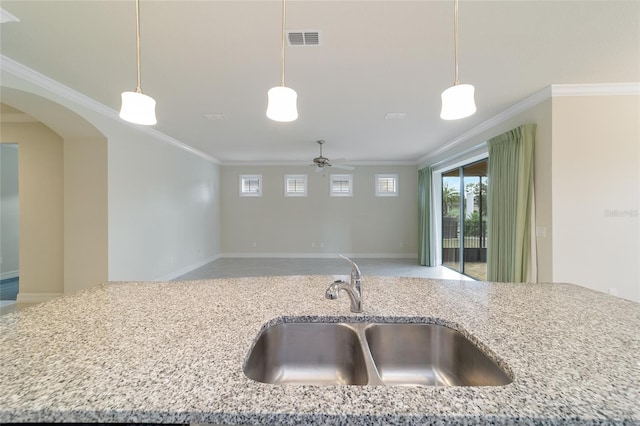 kitchen with ceiling fan, sink, hanging light fixtures, and ornamental molding