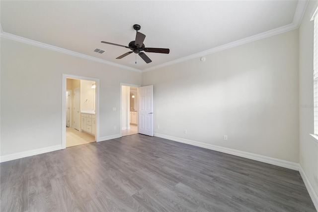 unfurnished bedroom with ceiling fan, wood-type flooring, ornamental molding, and ensuite bath