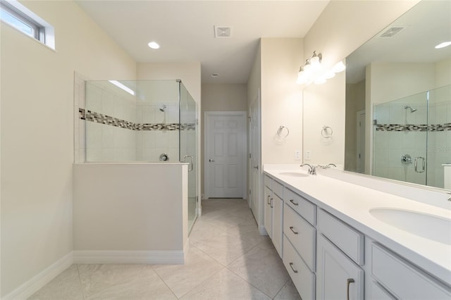 bathroom featuring vanity, tile patterned floors, and an enclosed shower