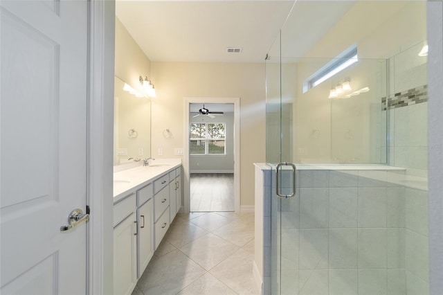 bathroom featuring walk in shower, vanity, tile patterned floors, and ceiling fan