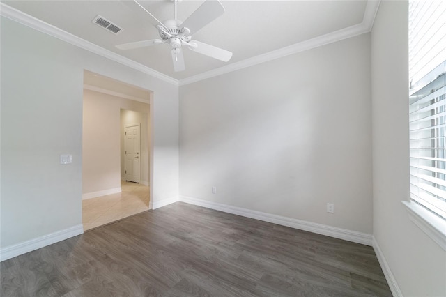 unfurnished room featuring hardwood / wood-style floors, a healthy amount of sunlight, and ornamental molding