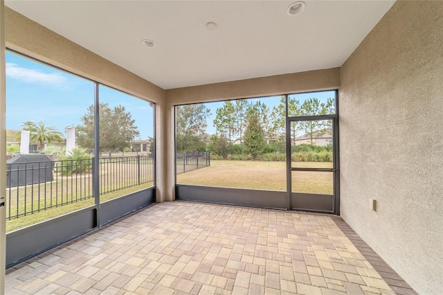 unfurnished sunroom featuring a wealth of natural light