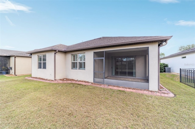 back of house featuring a sunroom, cooling unit, and a yard