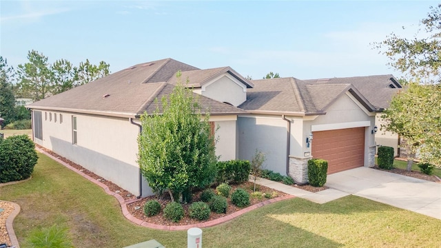 view of front of house with a front yard and a garage