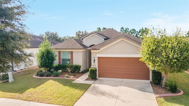 view of front of house with a front yard and a garage