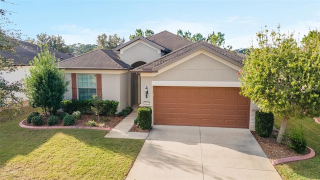 ranch-style house with a garage and a front lawn