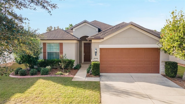 ranch-style home featuring a front lawn and a garage