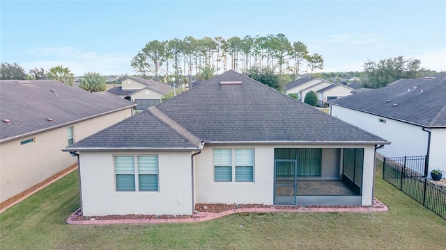 rear view of house featuring a lawn