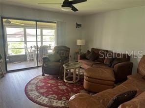 living room with hardwood / wood-style flooring and ceiling fan