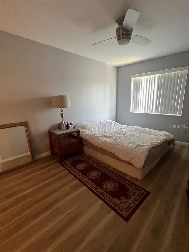 bedroom with hardwood / wood-style flooring and ceiling fan