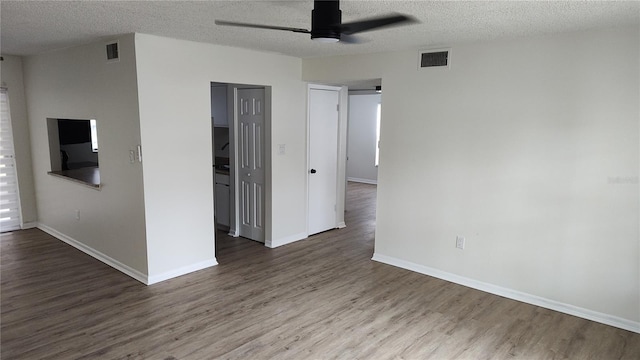 spare room with hardwood / wood-style flooring, ceiling fan, and a textured ceiling