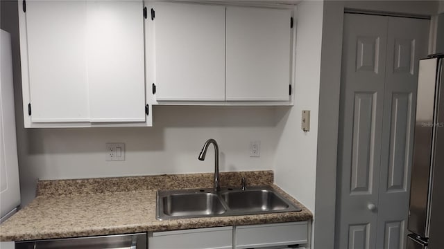 kitchen featuring sink, white cabinets, and stainless steel appliances