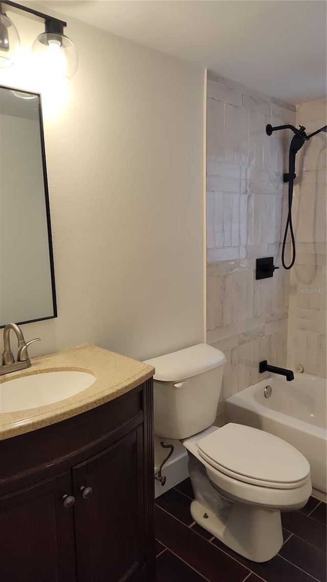 full bathroom featuring vanity, toilet, and tiled shower / bath combo