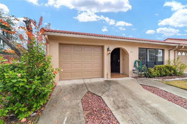 mediterranean / spanish-style home featuring a garage