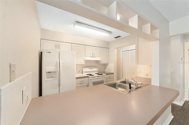 kitchen with white appliances, sink, decorative backsplash, a textured ceiling, and white cabinetry