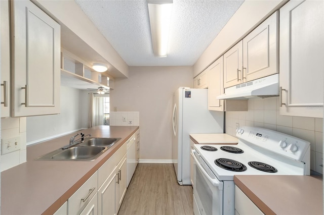 kitchen featuring white appliances, ceiling fan, sink, light hardwood / wood-style floors, and white cabinetry