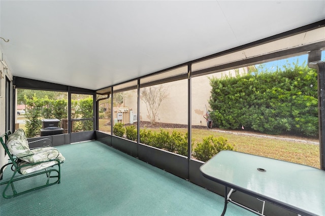 unfurnished sunroom featuring vaulted ceiling