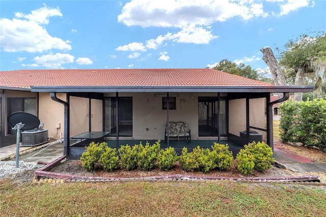 back of house featuring central AC unit and a sunroom