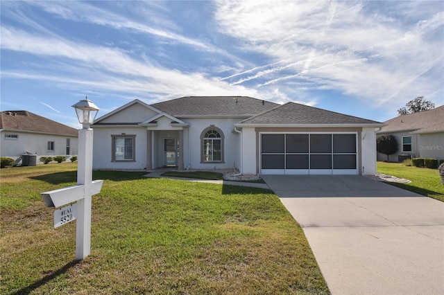 single story home with cooling unit, a garage, and a front yard